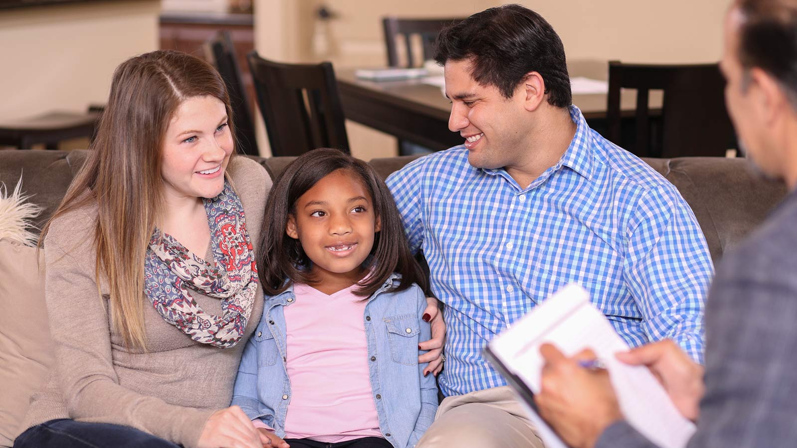 adoptive parents receiving parent counseling with their adopted child