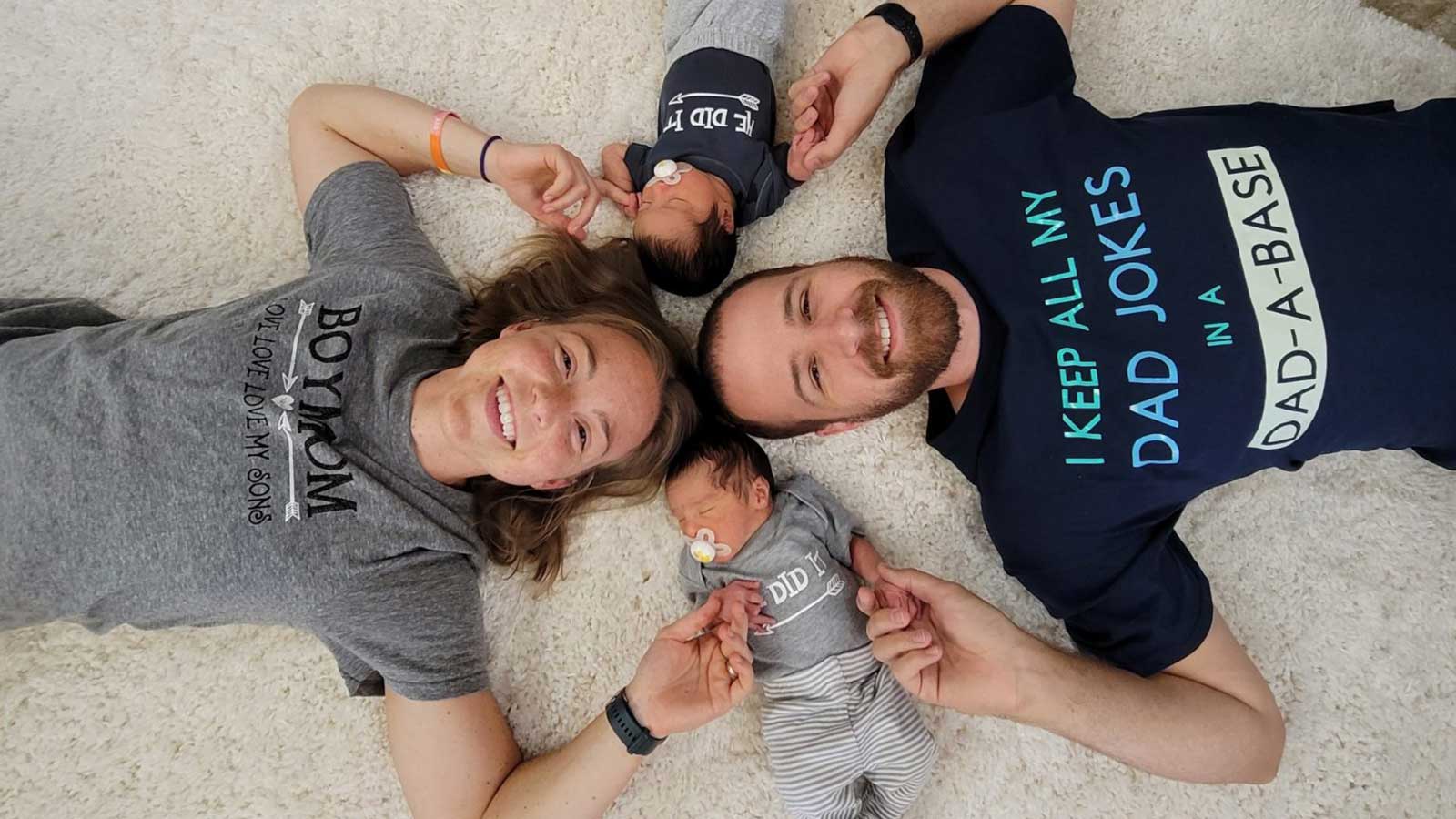 U.S. adoptive family smiling on floor with twin babies