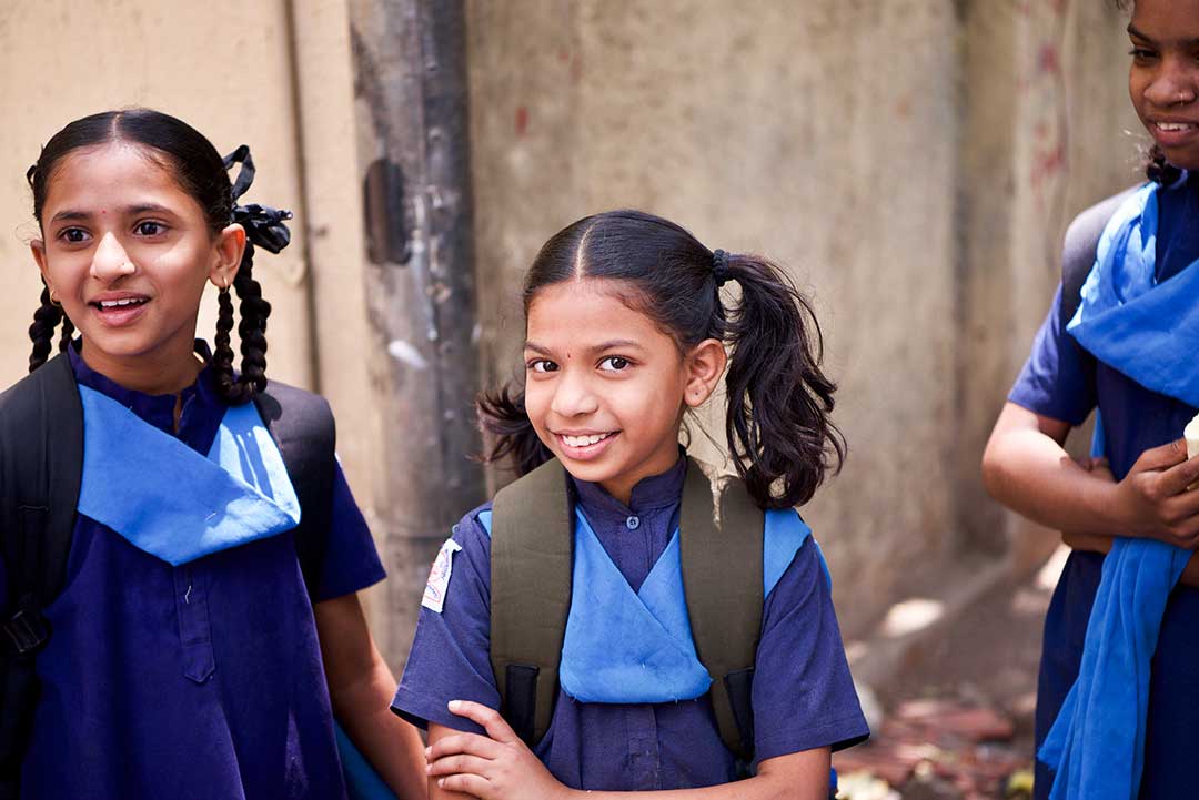 Girls wearing backpacks in India