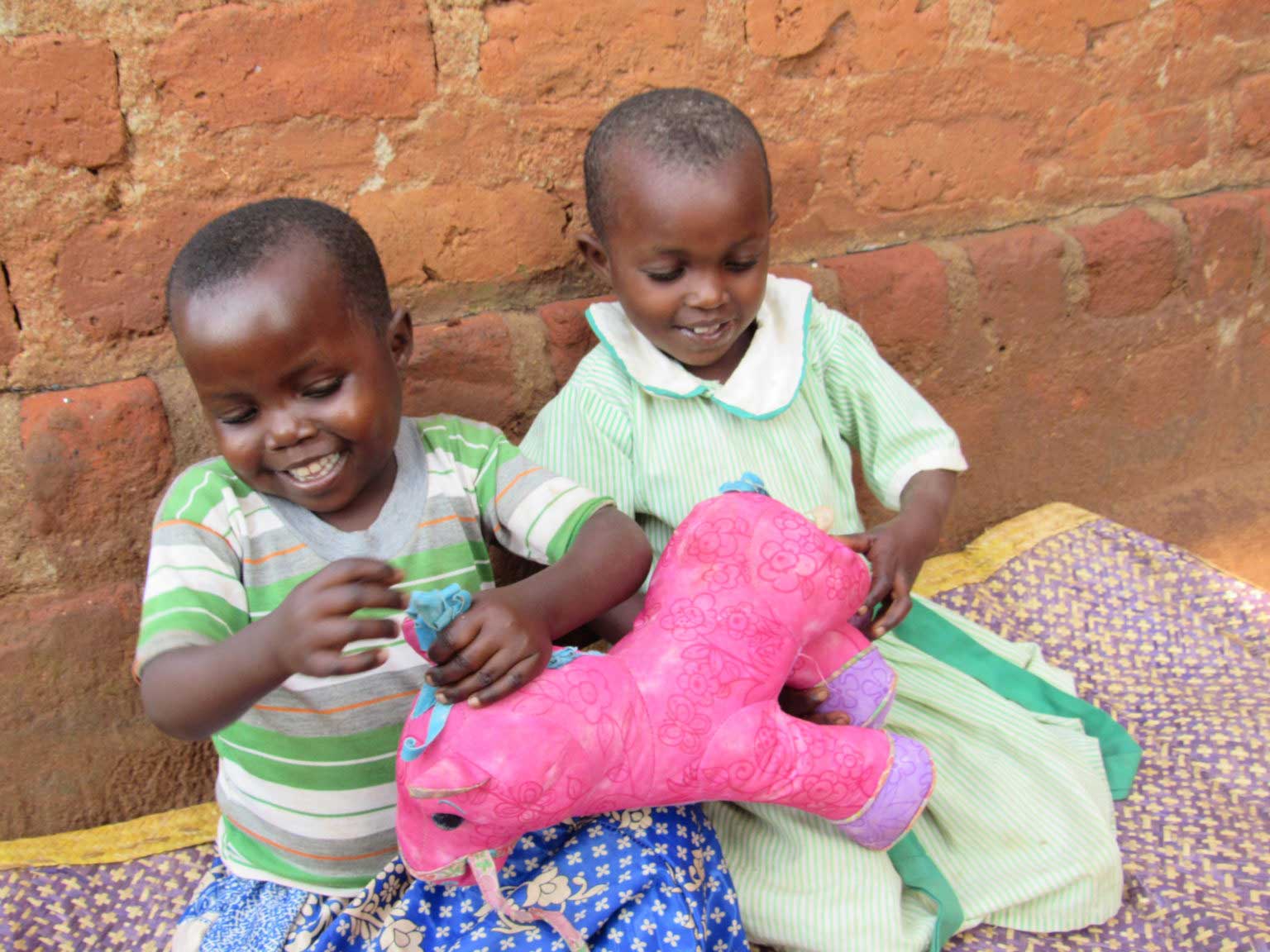 Uganda babies with pink toy