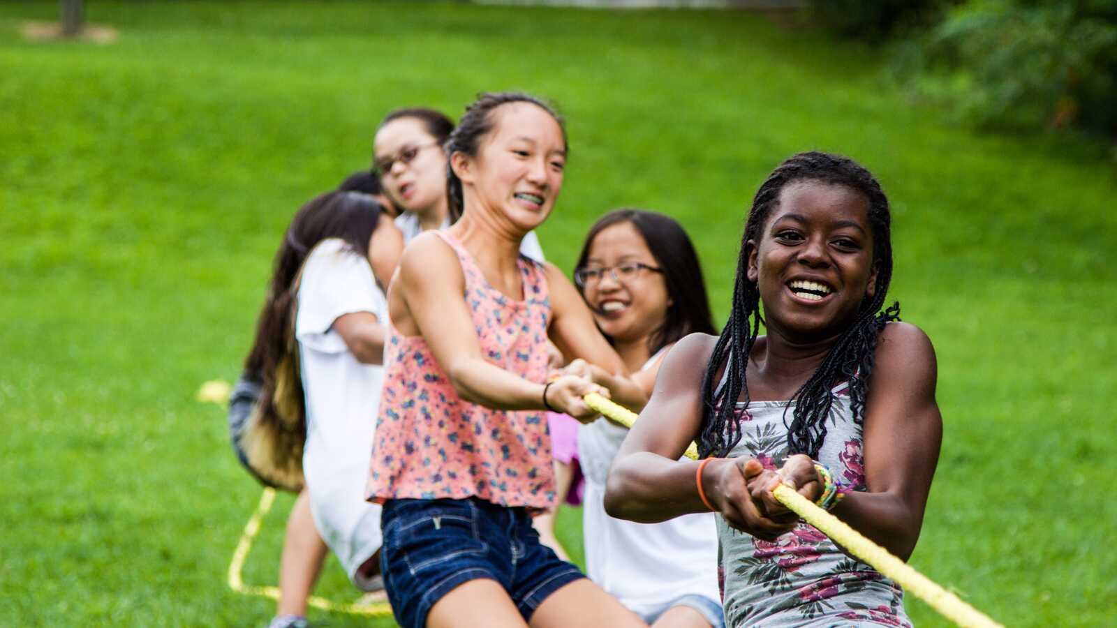 group of girls playing tug of war at adoptee summer camp