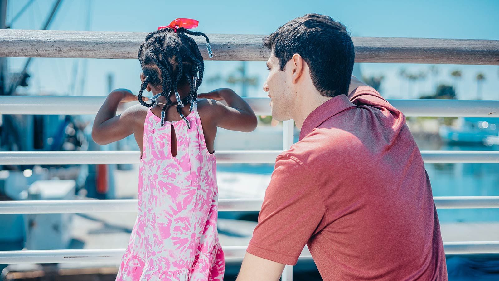 adopted daughter and white father on a bridge looking at the water