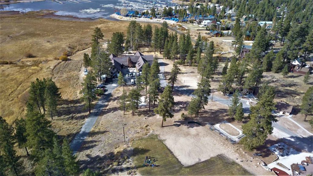 aerial view of campsite on lakeshore surrounded by trees