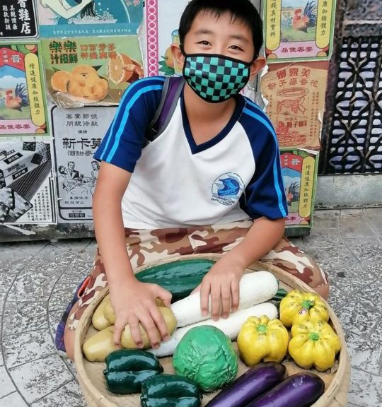 Niko with holding basket of vegetables