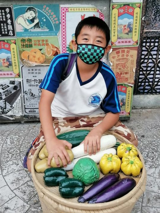 Niko with holding basket of vegetables