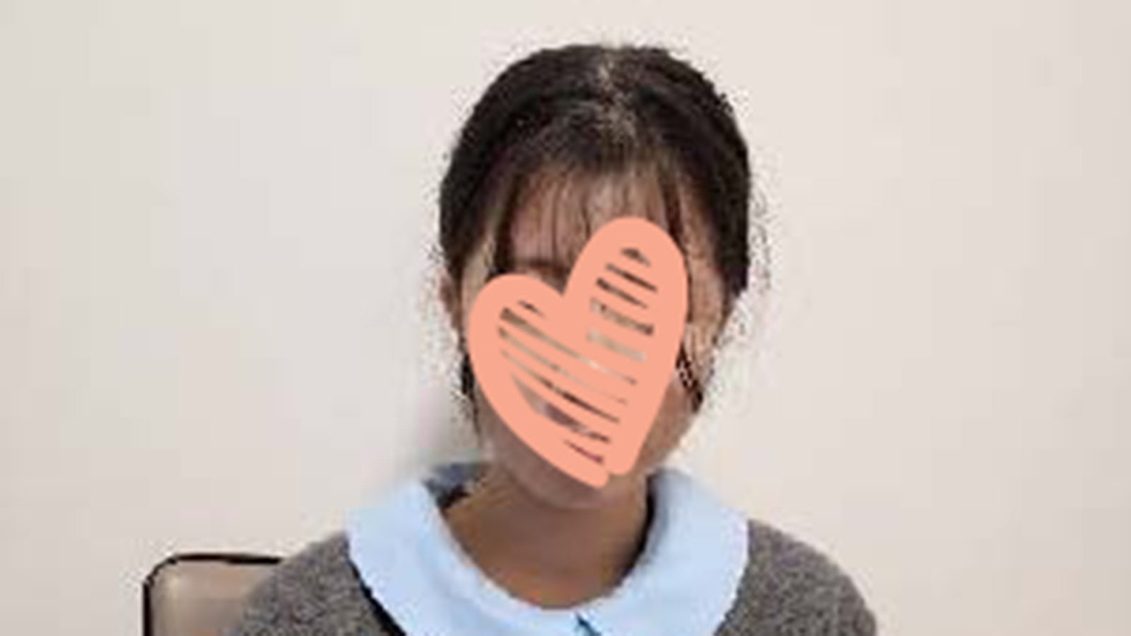 girl with heart graphic covering face needs adoptive family