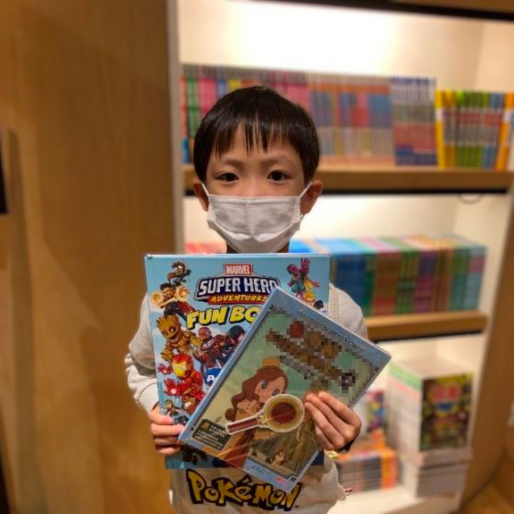 Boy holding up his books