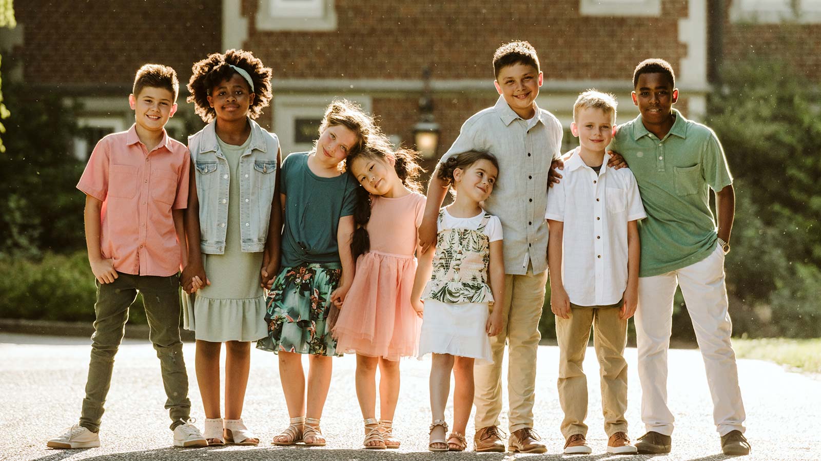 group of eight adopted siblings standing with arms around each other