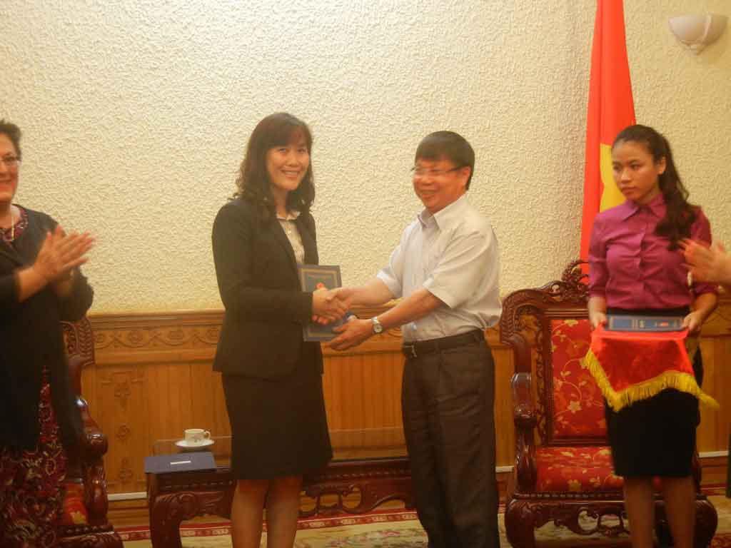 Director Nguyen Van Binh of the Central Adoption Authority in Vietnam presents our license to Hang Dam, Holt Vietnam's country director who works out of our office in Hanoi, Vietnam.