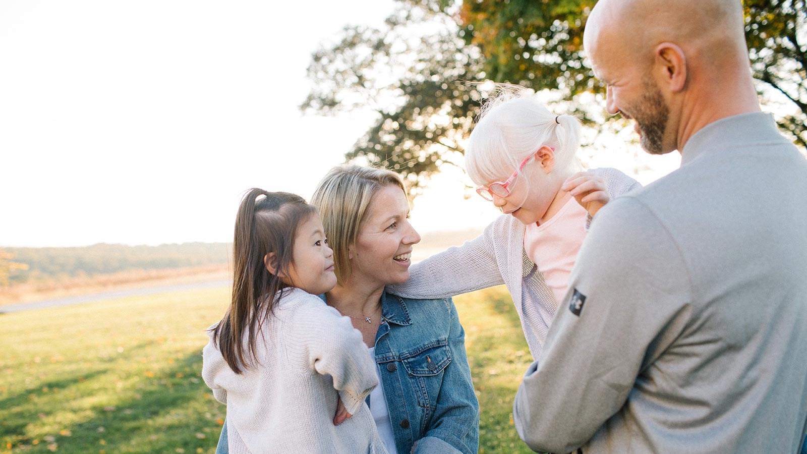 adoptive mother and father holding daughters adopted from China