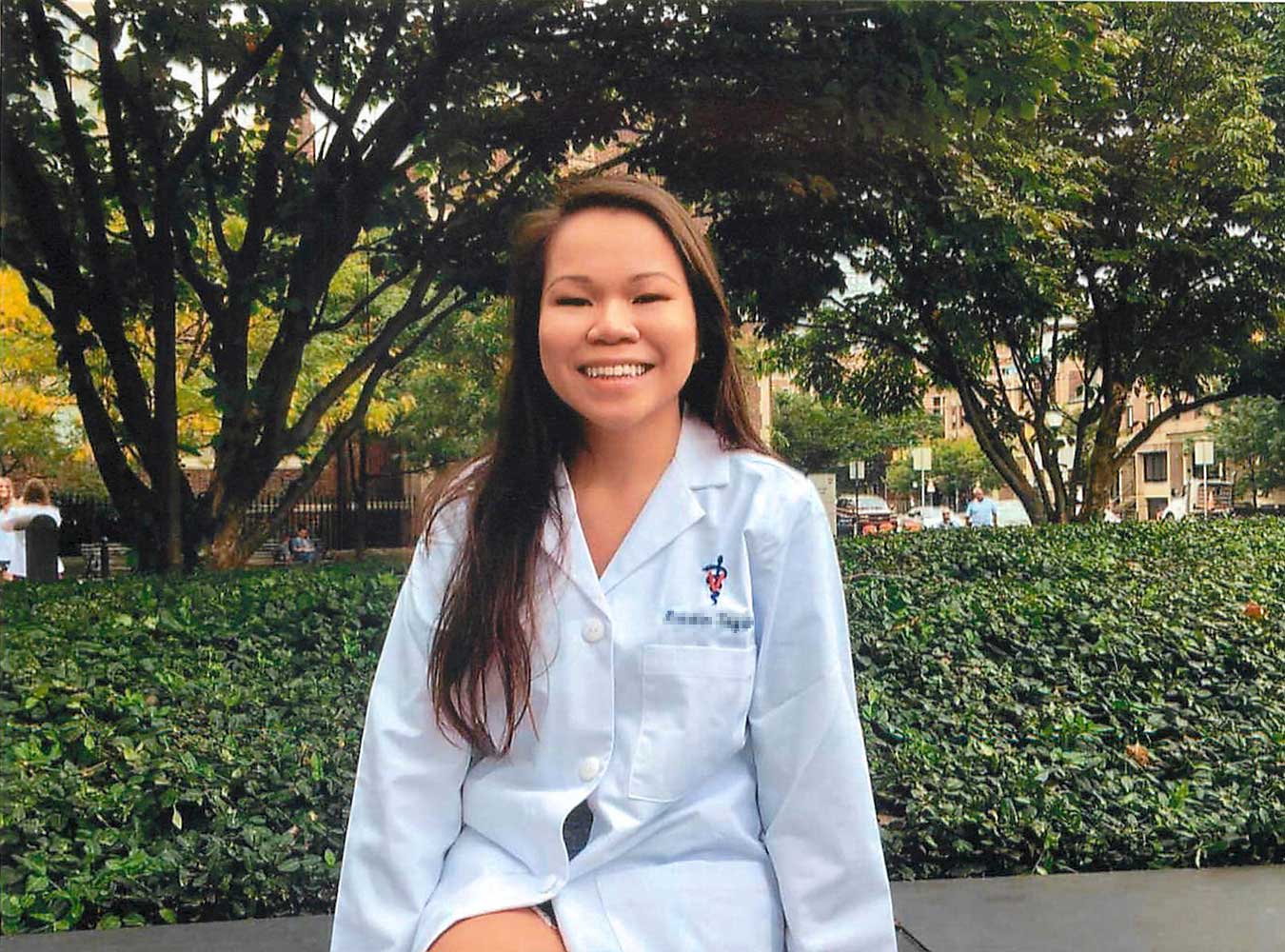 smiling adopted woman wearing veterinary coat