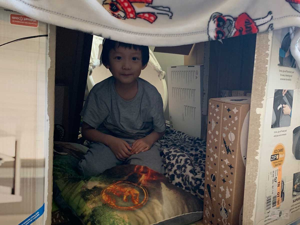 Boy in tent fort