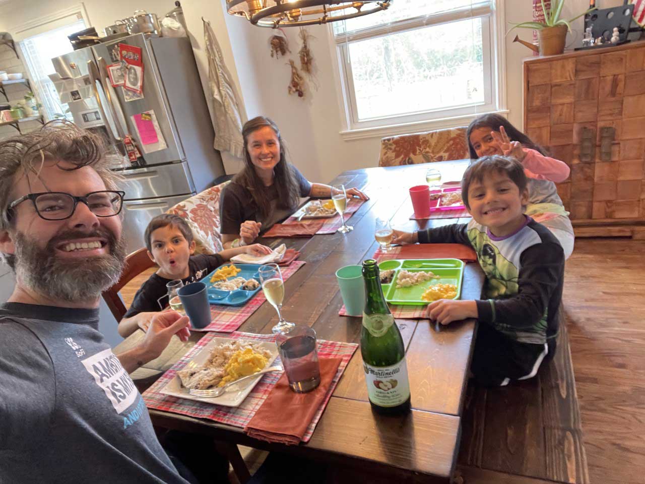 Adoptive parents eating breakfast with three older siblings adopted from Colombia