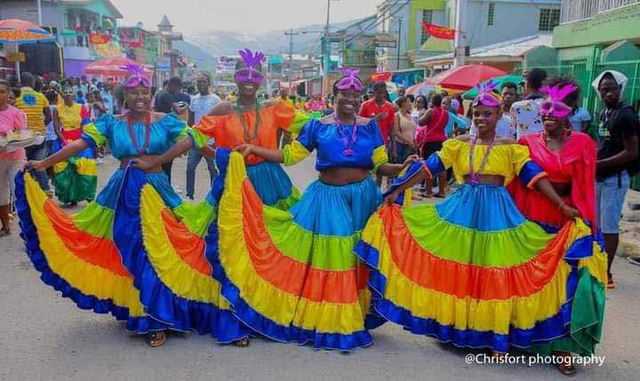 Women in colorful dresses and masks during Carnival in Haiti