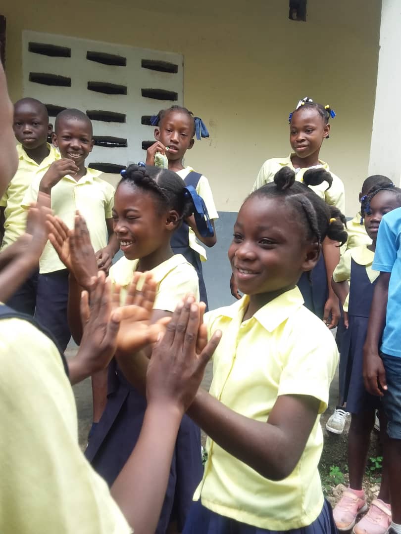 sponsored child in Haiti playing games with friends