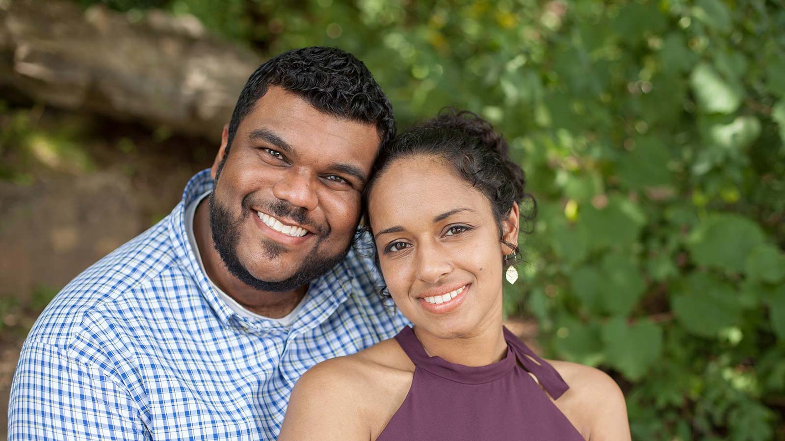 smiling man with beard and smiling woman with curly hair