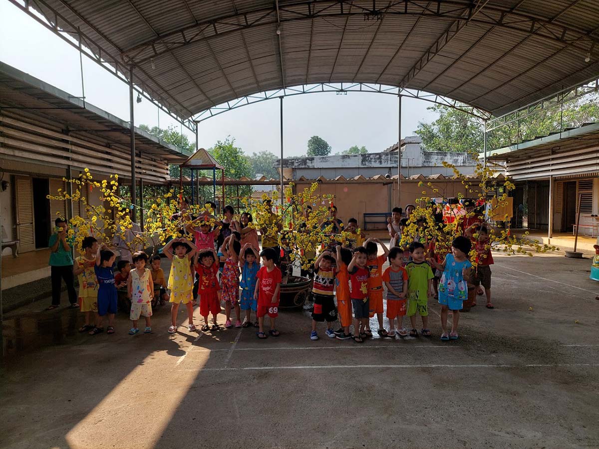 children dancing outside celebrating tet in Vietnam