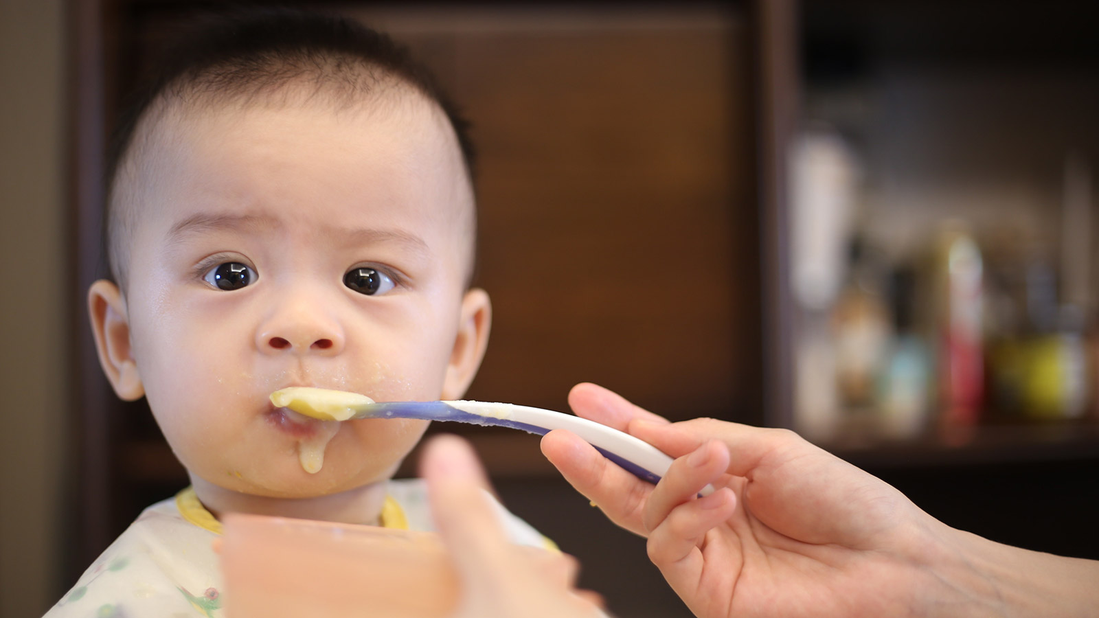 baby eating from a spoon