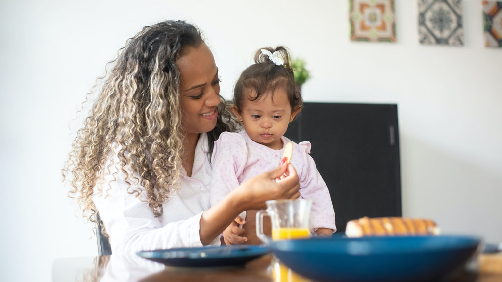 mother feeding her child a cracker