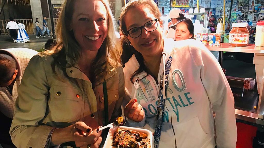 two smiling women at a restaurant