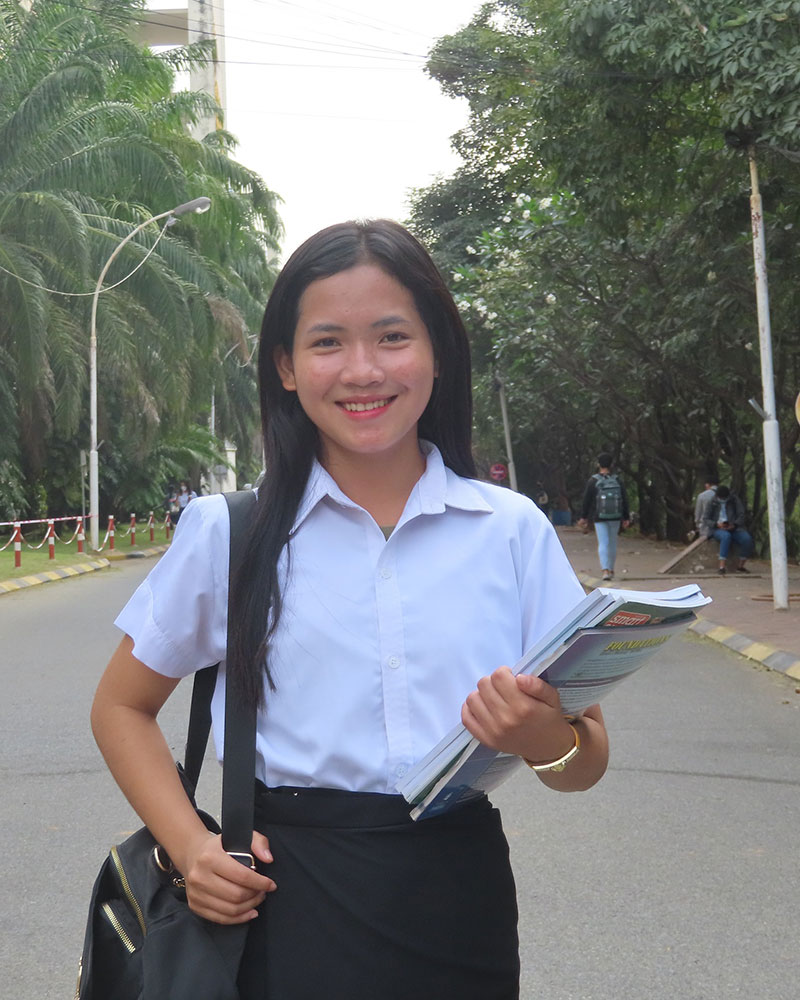cambodian girl in holt education program holding textbooks