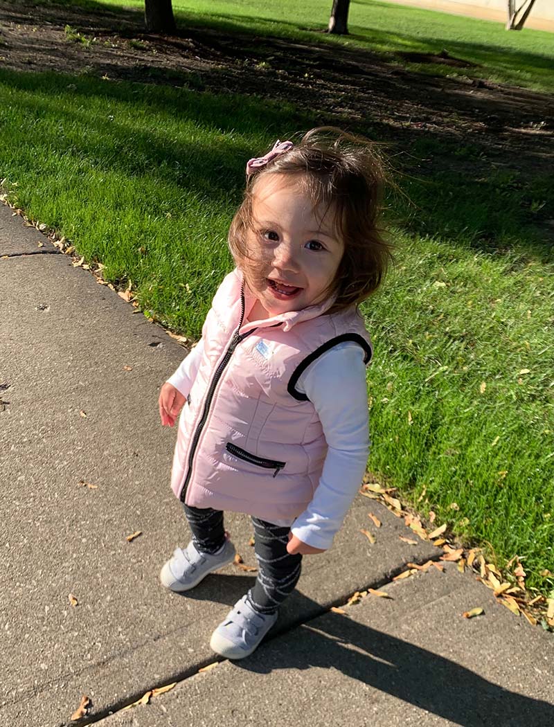 smiling little girl in pink vest