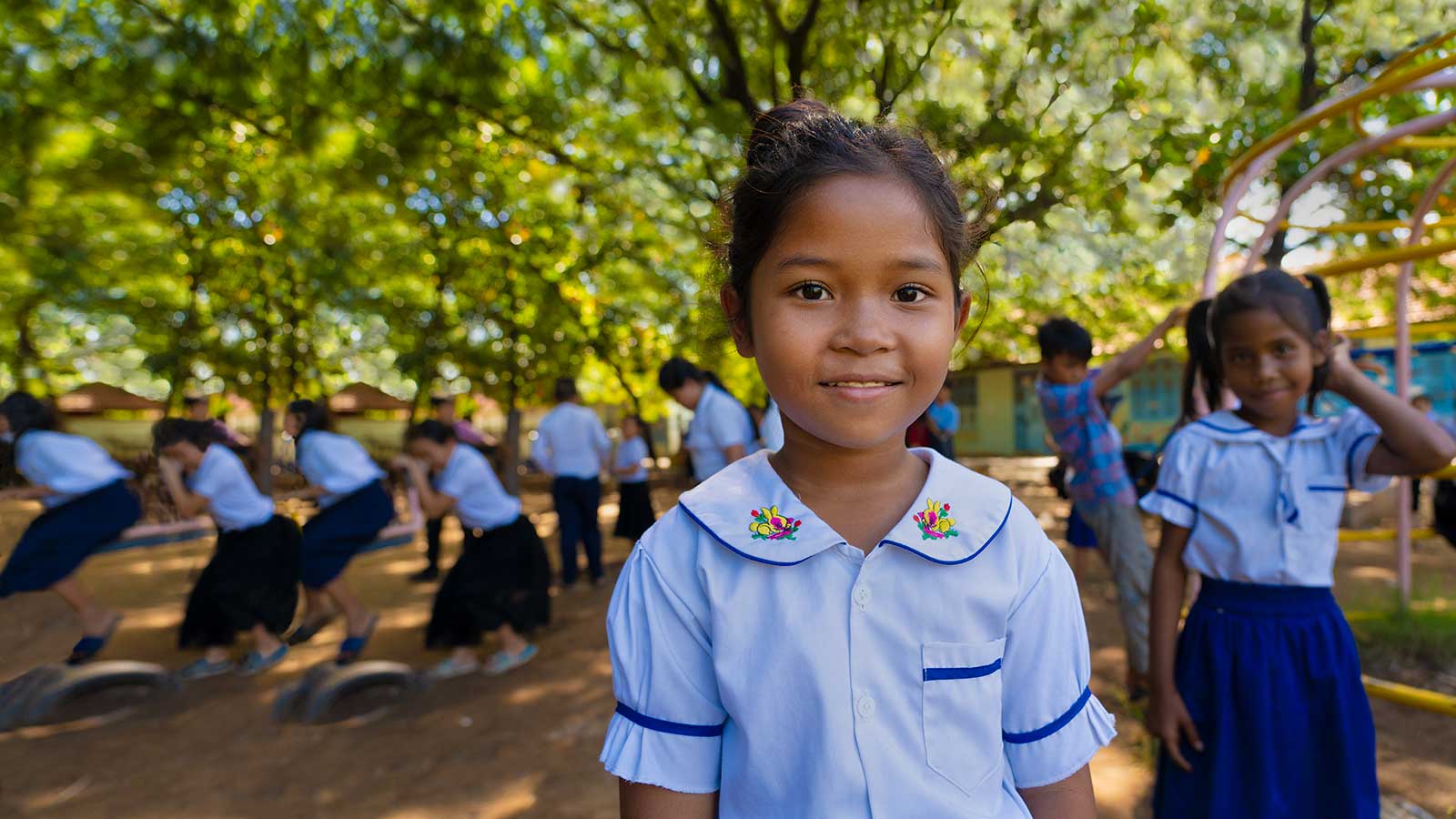 smiling girl sponsored child at school with friends