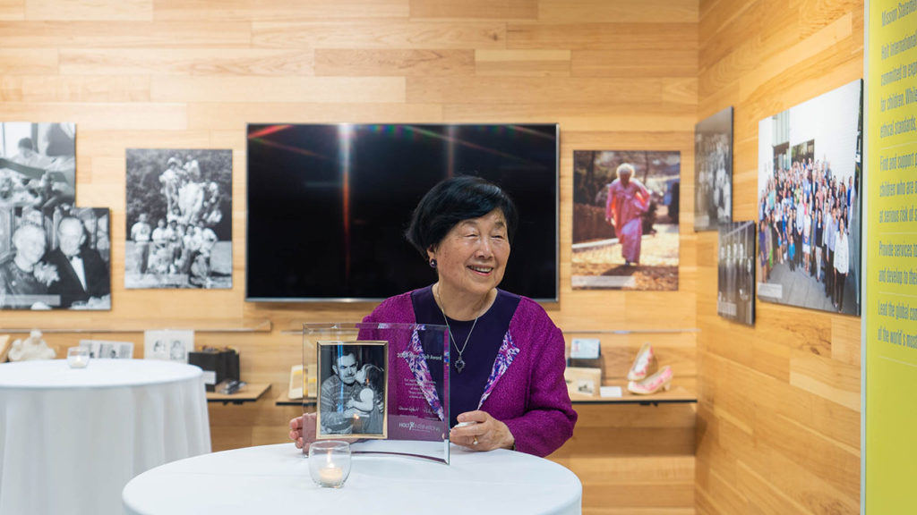 smiling Nancy Kim holding Harry Holt award