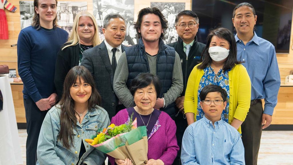 nancy kim and family holding flowers at ceremony to receive harry holt award