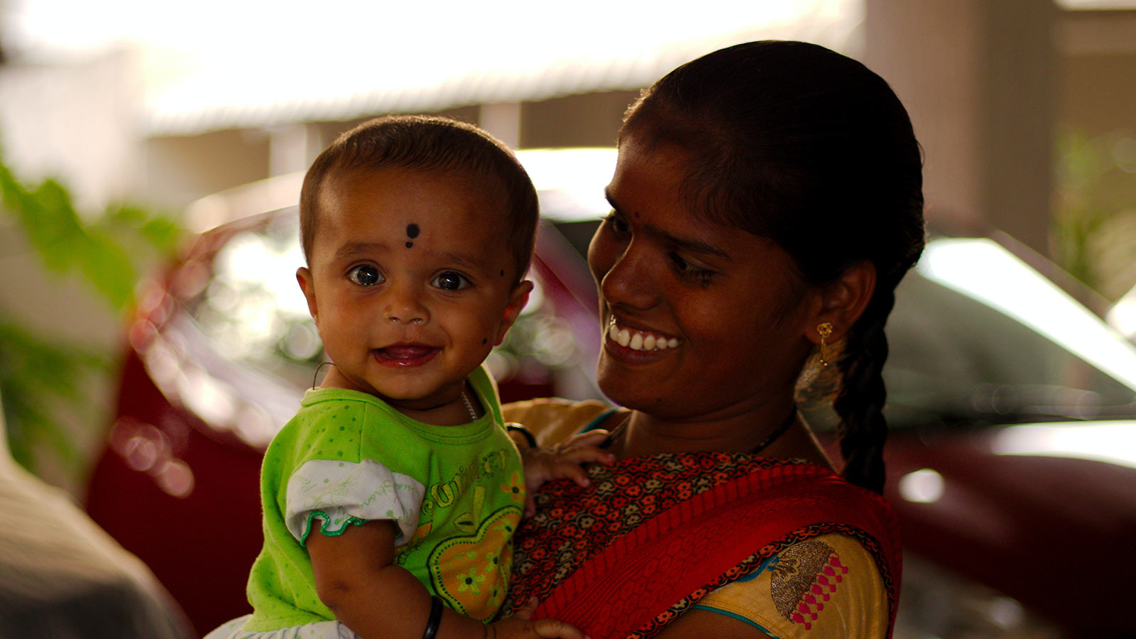 mother holding baby in india
