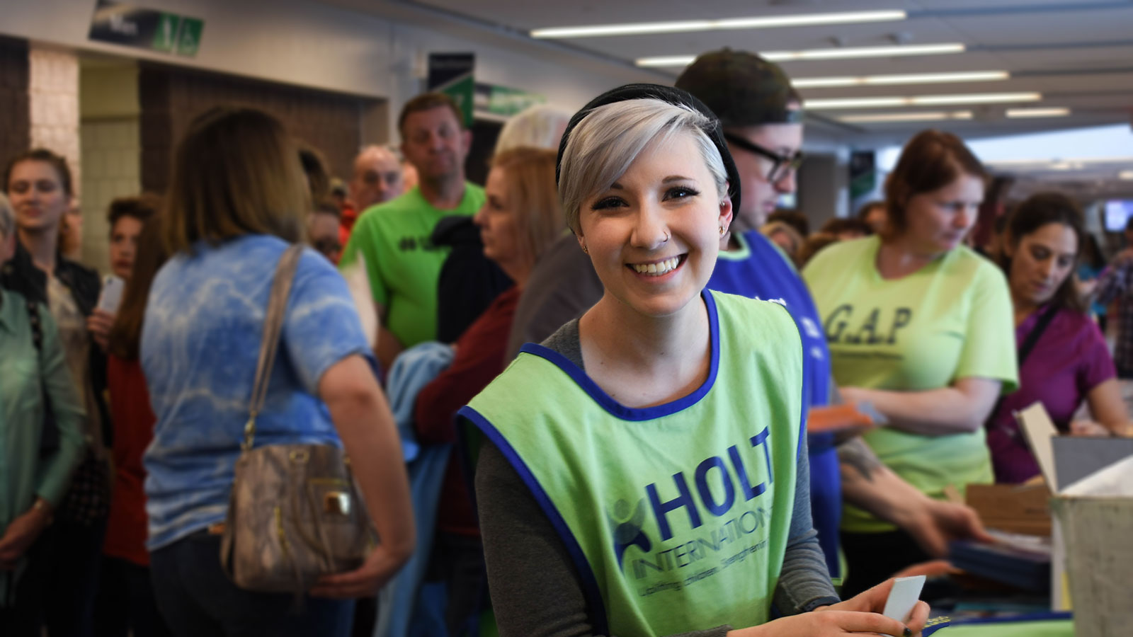 woman volunteer with Holt smiling at camera