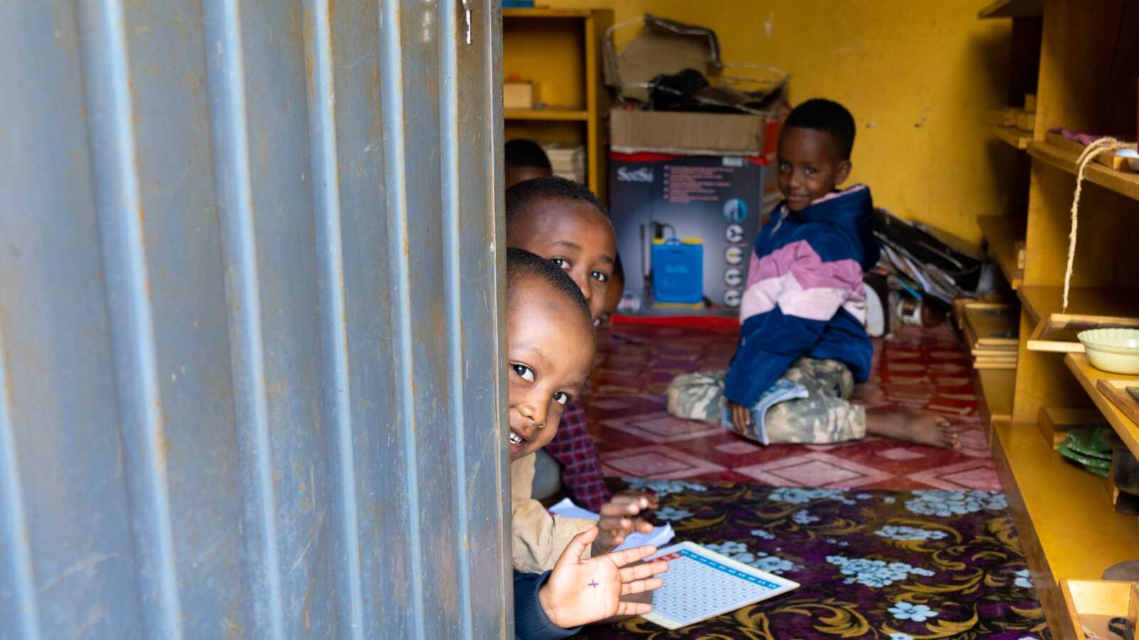 Students wave hello at an early childhood development center in Ethiopia.