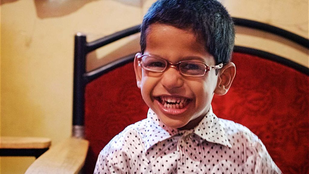 smiling boy from India with special needs