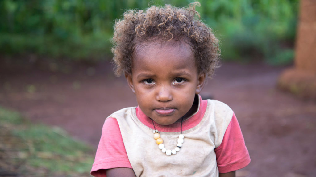 Young girl in Ethiopia sitting outside
