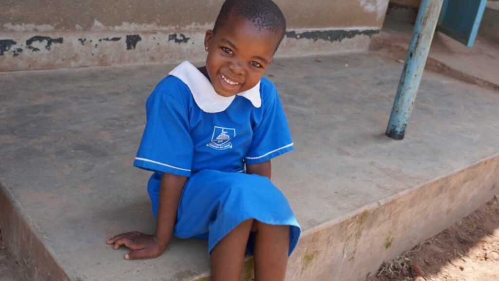 Girl in Uganda in blue school uniform