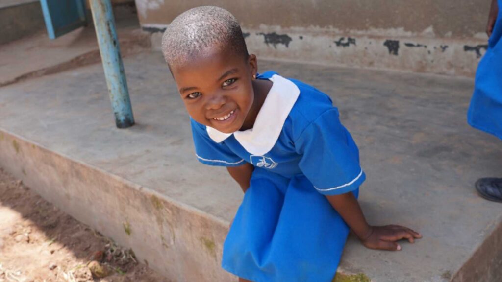 Girl in Uganda in blue school uniform
