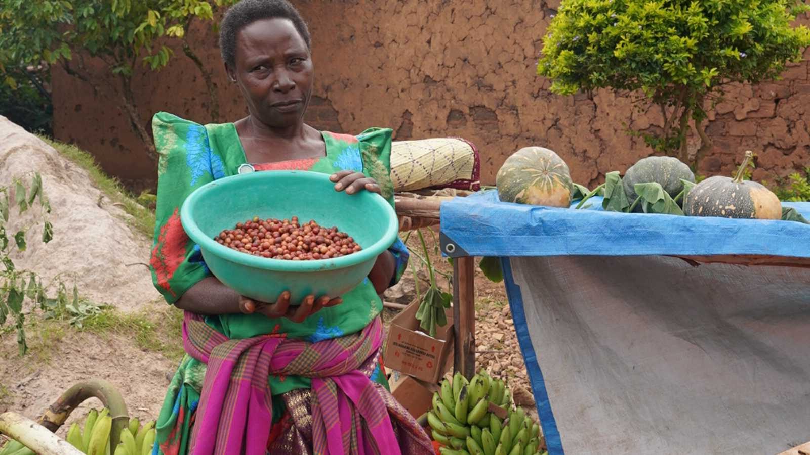 Women holding basket of food, green banana