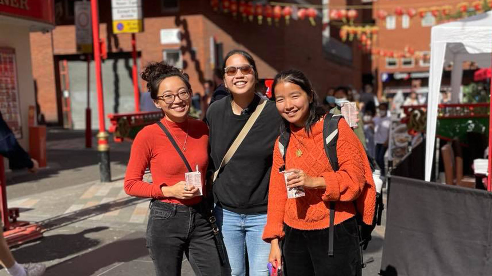 three adoptees smiling for a group photo