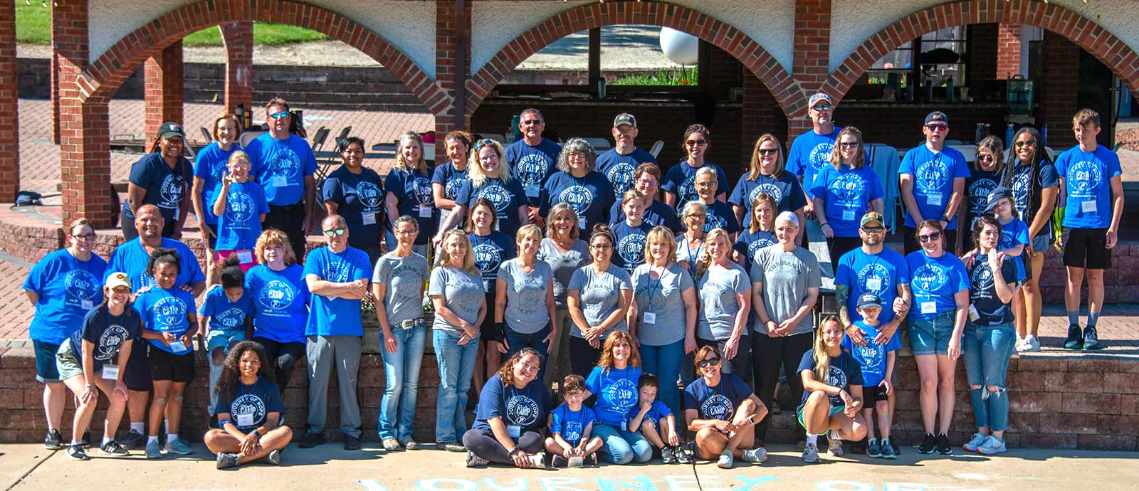 Journey of Hope camp 2022, parents, children and staff in a group photo, wearing camp T-shirts