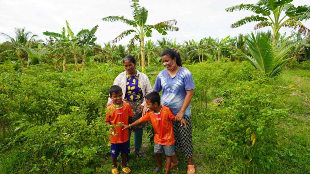 Sponsored twins with their mom and grandma on their farm in Thailand