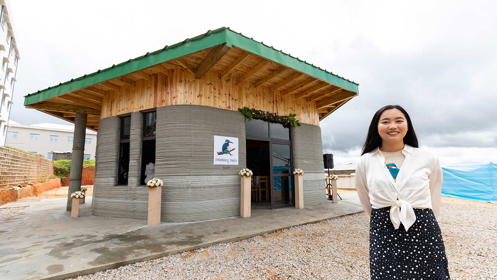 maggie grout thinking huts founder in front of first printed school