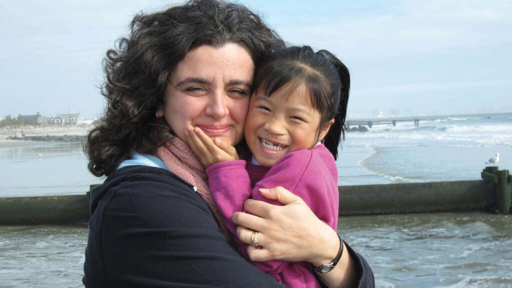 Adoptive mom with her 5-year-old daughter, adopted from China, on the beach