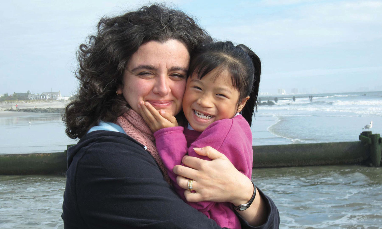 Adoptive mom with her 5-year-old daughter, adopted from China, on the beach