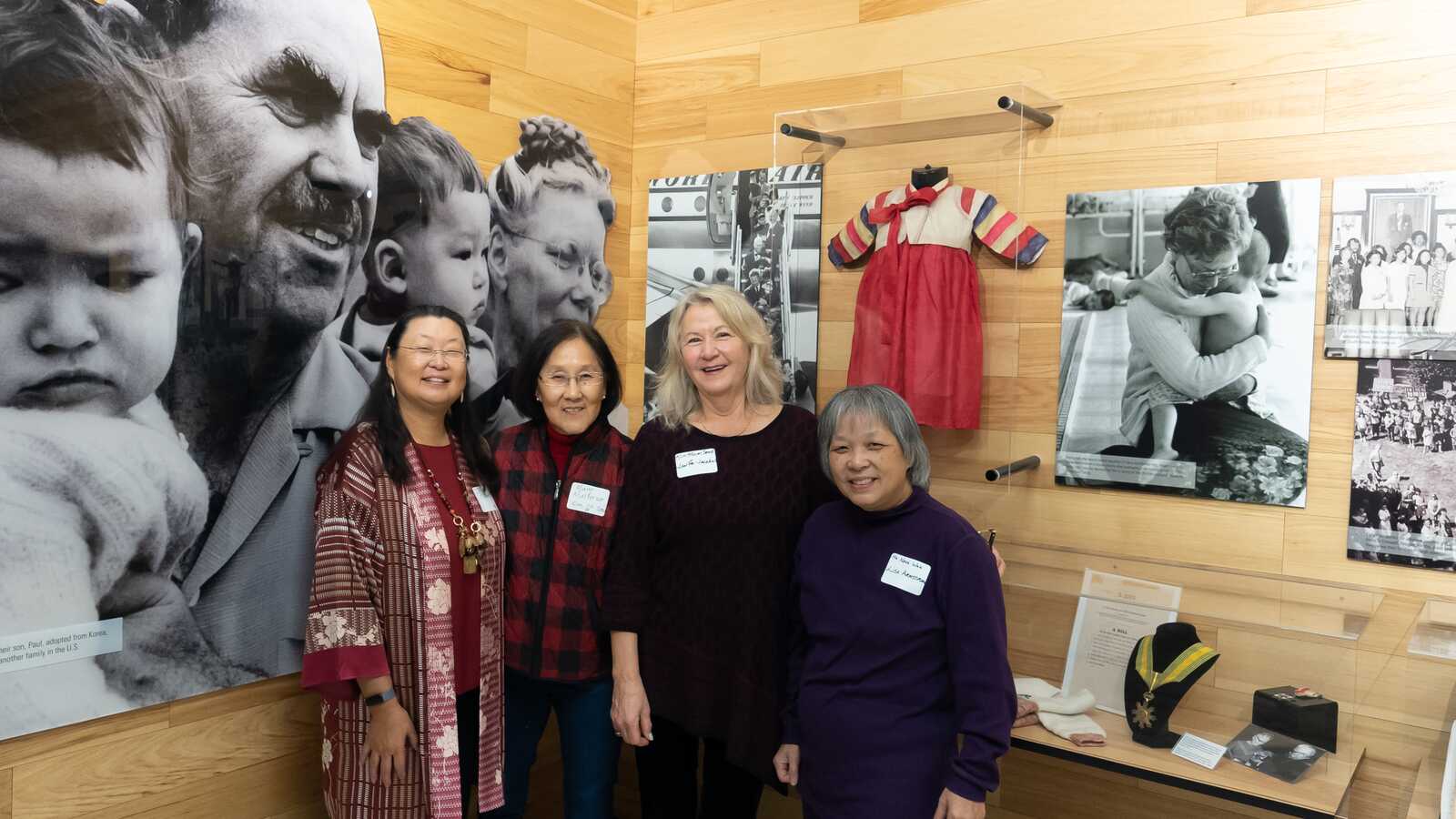 Adoptees at an adoptee reception before Holt history display