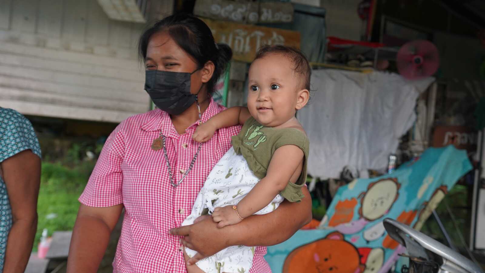 Mother holding daughter in Thailand