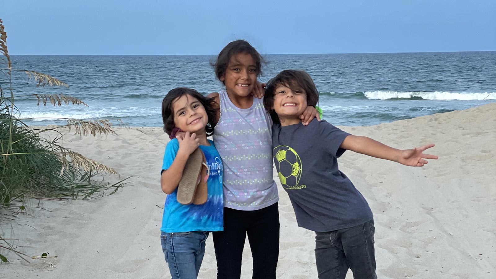 Siblings adopted from Colombia on the beach