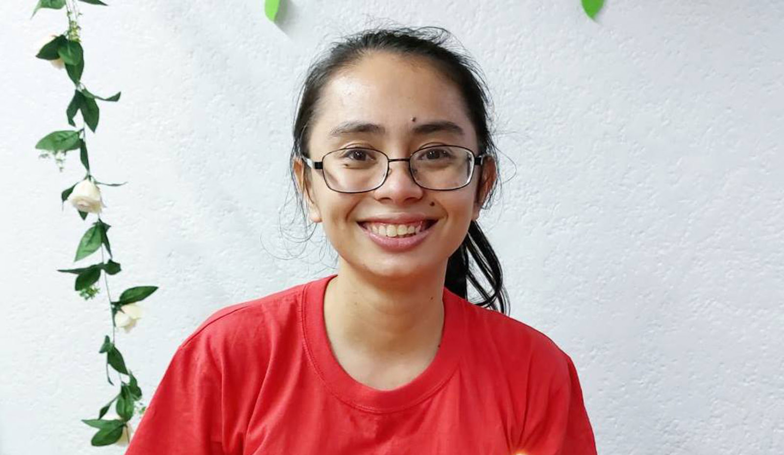 Smiling 25-year-old graduate of the ILEA program for aged-out orphans in the Philippines