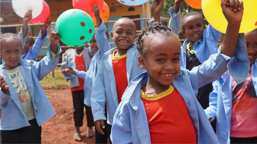Happy children at a birthday party provided through Holt International