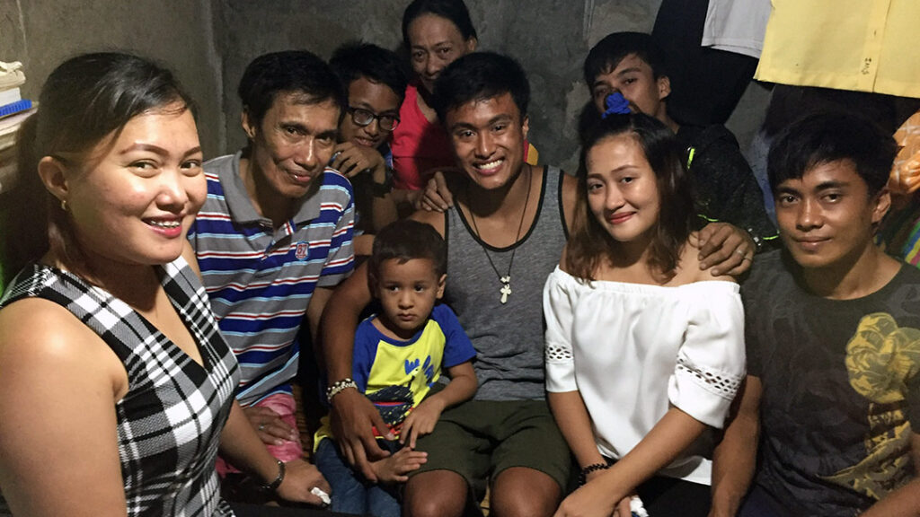 A group photo of an adoptee and his birth family in the Philippines