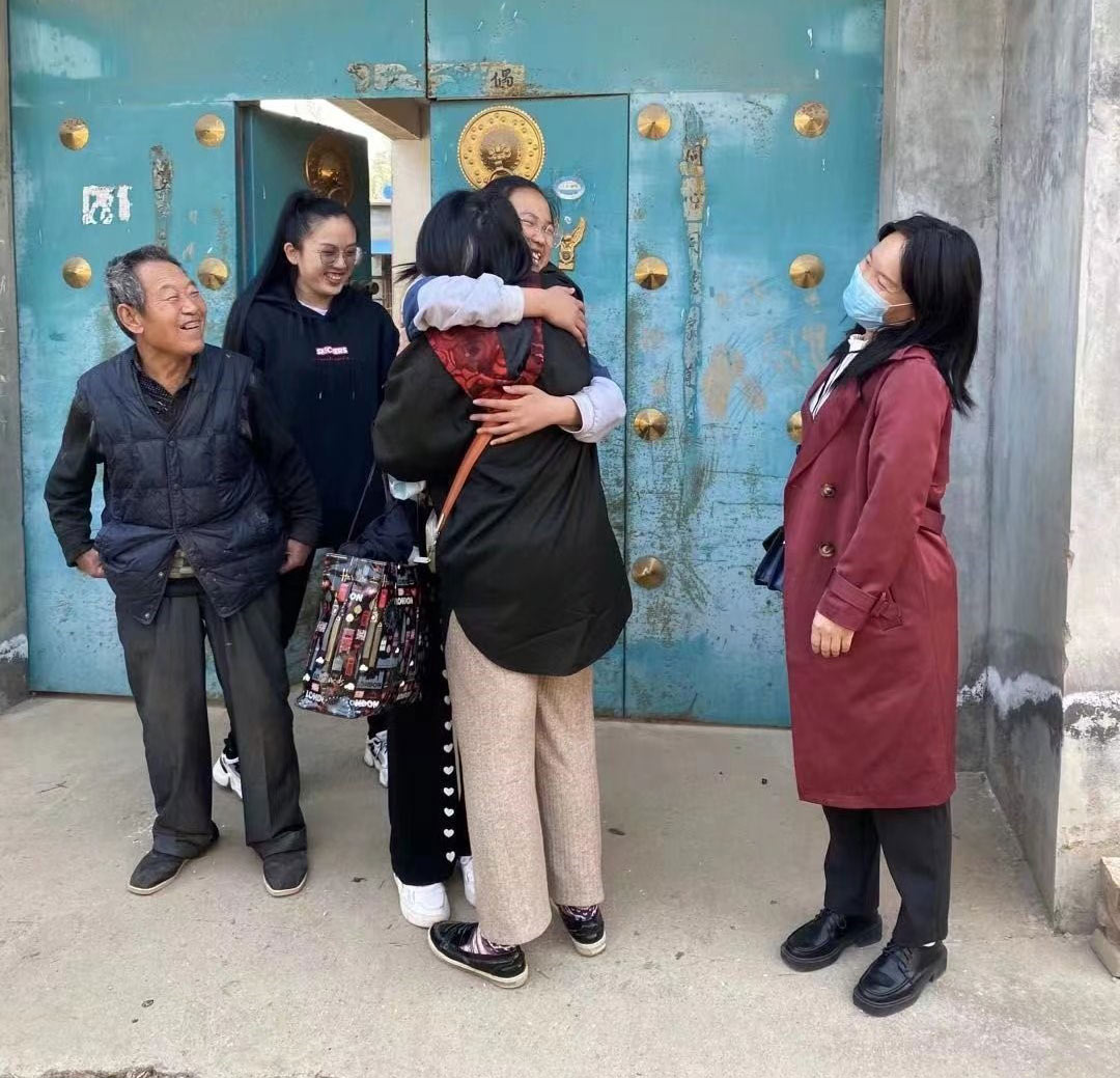 Chun, a girl in child sponsorship in China, hugs her Holt social worker